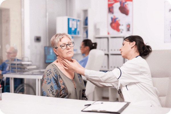 A mature woman is being checked because she has pain on her neck.
