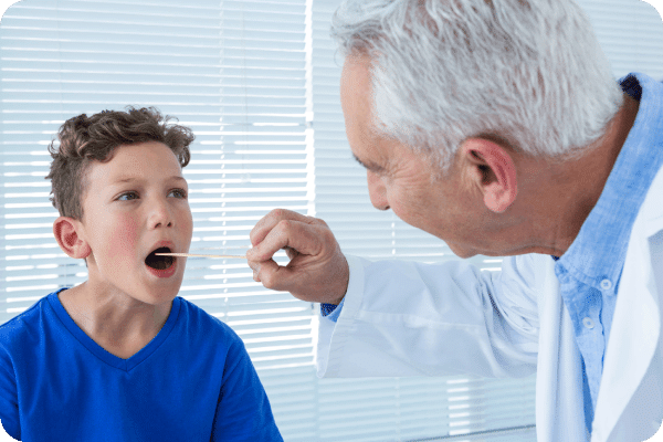 Doctor is checking the kid's throat with the latest equipment.