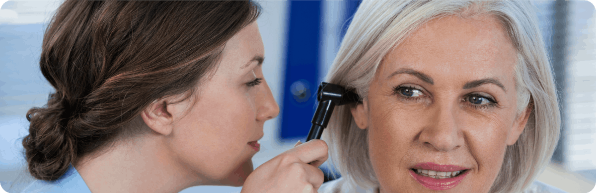 Ear test being performed to a mature patient.