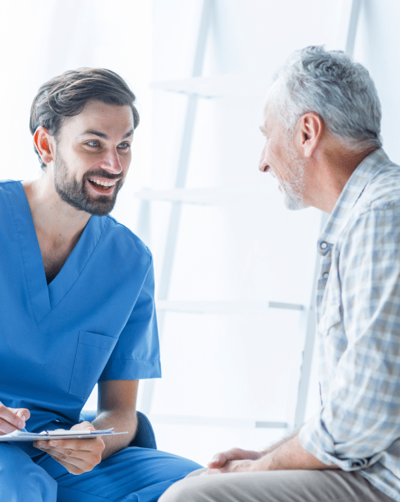 cheerful-doctor-talking-with-elderly-patient