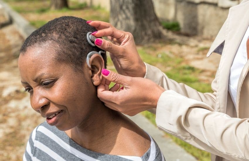 A woman being implanted with the Cochlear device