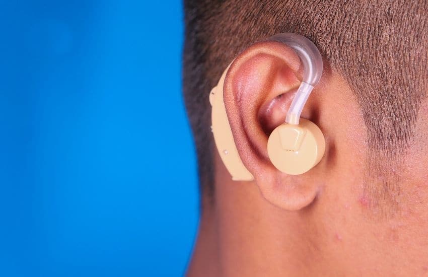 A guy using his cochlear implant device'.