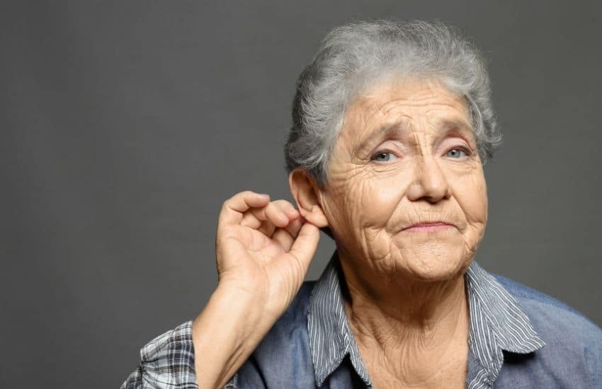 A mature woman with cochlear implant to provide sound perception.