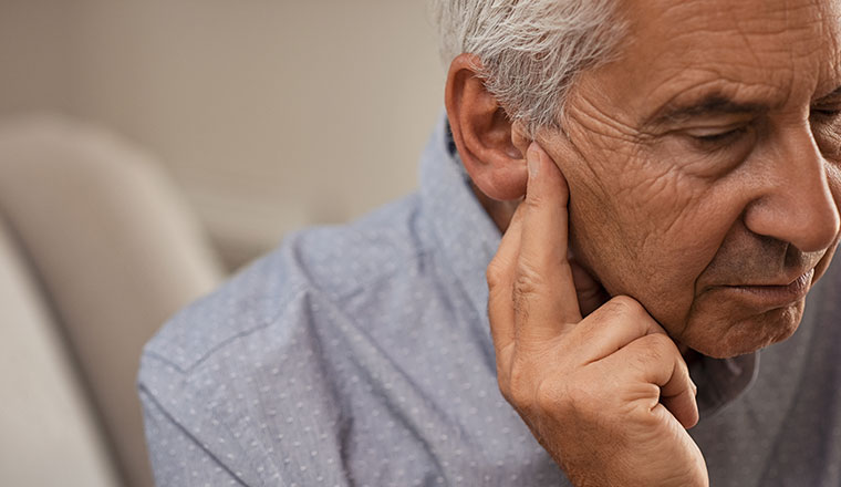 Senior man in need of hearing restoration treatment