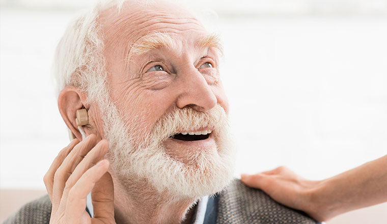 Senior patient undergoing hearing restoration treatment